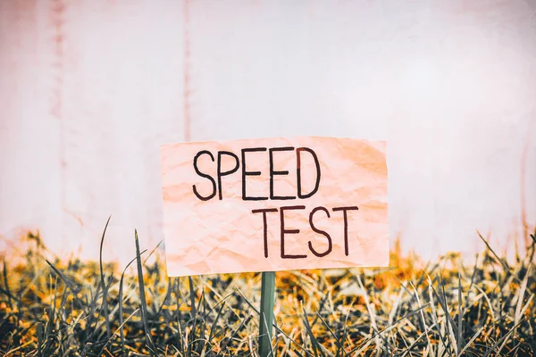 Handwriting text writing Speed Test. Concept meaning psychological test for the maximum speed of performing a task Plain empty paper attached to a stick and placed in the green grassy land.