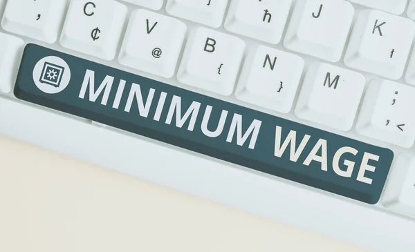 Handwriting text Minimum Wage. Concept meaning the lowest wage permitted by law or by a special agreement White pc keyboard with empty note paper above white background key copy space.