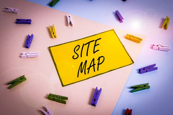 Word writing text Site Map. Business concept for designed to help both users and search engines navigate the site Colored clothespin paper empty reminder yellow blue floor background office.