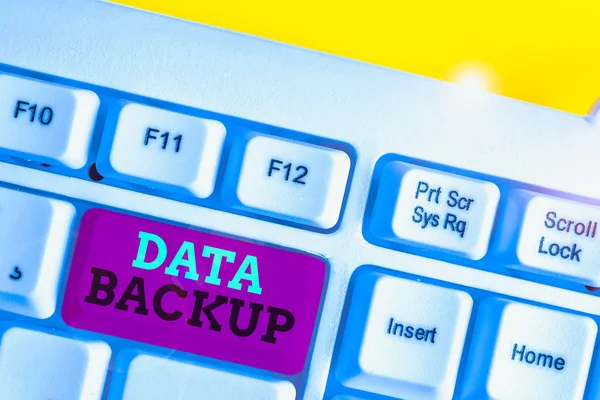 Word writing text Data Backup. Business concept for copy of important data that is stored on an alternative location White pc keyboard with empty note paper above white background key copy space.