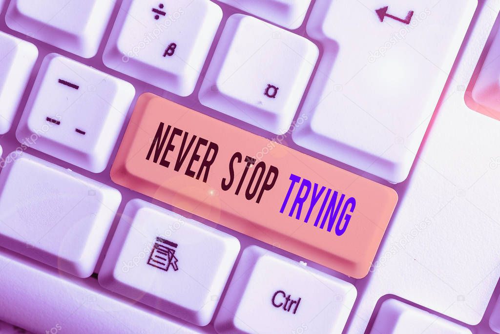 Text sign showing Never Stop Trying. Conceptual photo Do not give up Continue to Try Again Keep on Doing White pc keyboard with empty note paper above white background key copy space.
