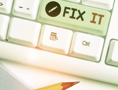 Fix It 'i gösteren kavramsal el yazısı. Kavram, belirli bir yerde ya da pozisyonda güvenli bir şekilde bir şeyi tamir etmek anlamına gelir.