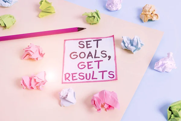 Word writing text Set Goals, Get Results. Business photo showcasing Establish objectives work for accomplish them Colored crumpled papers empty reminder blue yellow background clothespin