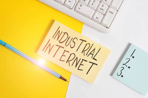 Writing note showing Industrial Internet. Business concept for use of the internet of things in industrial sectors Paper with copy space and keyboard above orange background table
