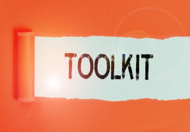 Text sign showing Toolkit. Business photo text set of tools kept in a bag or box and used for a particular purpose Cardboard which is torn in the middle placed above a plain table backdrop