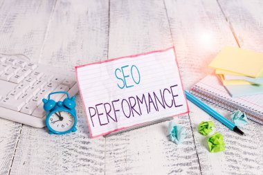 Word writing text Seo Perforanalysisce. Business photo showcasing increase the quantity and quality of traffic to website Notepaper stand on buffer wire in between computer keyboard and math sheets
