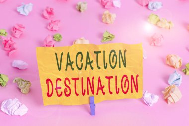 Handwriting text writing Vacation Destination. Conceptual photo a place where showing go for holiday or relaxation Colored crumpled papers empty reminder pink floor background clothespin