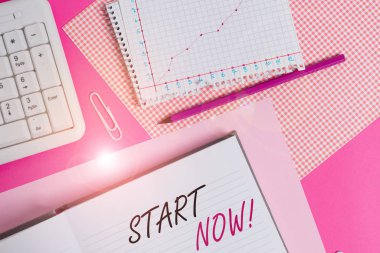 Text sign showing Start Now. Business photo showcasing do not hesitate get working or doing stuff right away Writing equipments and computer stuffs placed above colored plain table