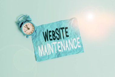 Conceptual hand writing showing Website Maintenance. Concept meaning act of regularly checking your website for issues Metal vintage alarm clock crush sheet sky colored background