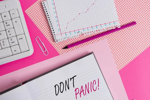 Text sign showing Don T Panic. Business photo showcasing suddenly feel so worried or frightened that you can not behave Writing equipments and computer stuffs placed above colored plain table