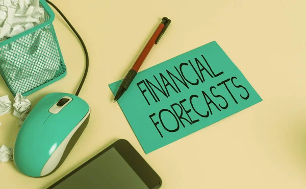 Conceptual hand writing showing Financial Forecasts. Concept meaning estimate of future financial outcomes for a company crumpled paper in bin placed next to modern gadget and stationary