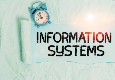 Handwriting text writing Information Systems. Conceptual photo study of systems with a exact reference to information Alarm clock and torn cardboard placed above plain pastel table backdrop