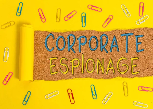 Text sign showing Corporate Espionage. Business photo text form of espionage conducted for commercial purpose Paper clip and torn cardboard placed above a wooden classic table backdrop