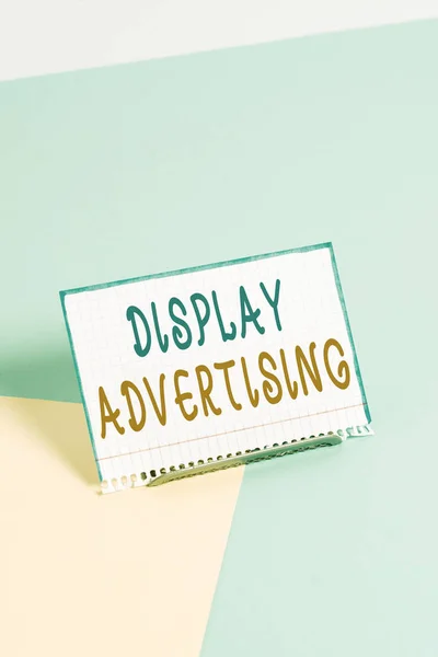 Text sign showing Display Advertising. Business photo showcasing online advertising that is typically a designed image Paper placed tilted above buffer wire on soft pastel multi colours backdrop