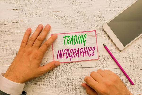 Conceptual hand writing showing Trading Infographics. Concept meaning visual representation of trade information or data Hand hold note paper near writing equipment and smartphone