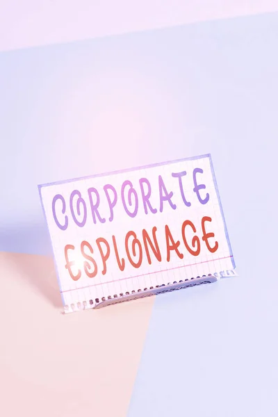 Text sign showing Corporate Espionage. Business photo showcasing form of espionage conducted for commercial purpose Paper placed tilted above buffer wire on soft pastel multi colours backdrop