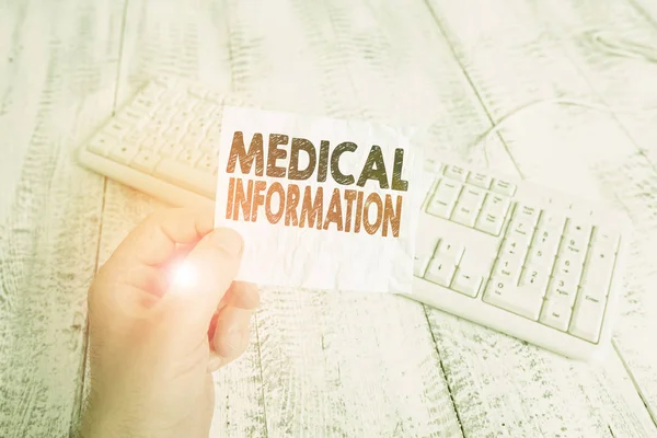 Writing note showing Medical Information. Business concept for Healthrelated information of a patient or a demonstrating Man holding colorful reminder square shaped paper wood floor