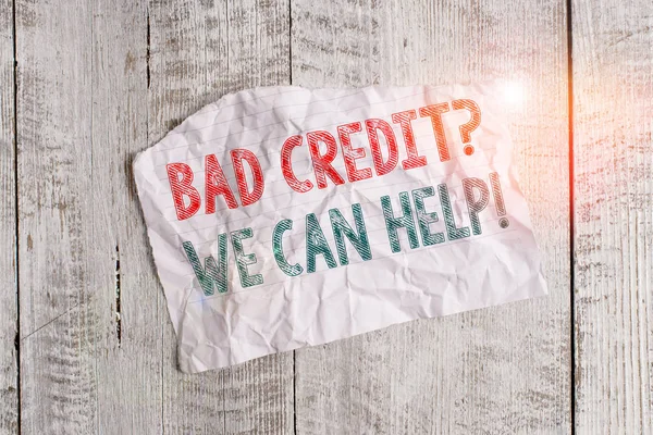 Text sign showing Bad Credit question We Can Help. Business photo showcasing Borrower with high risk Debts Financial Crumpled torn paper half broken placed above classic wooden background