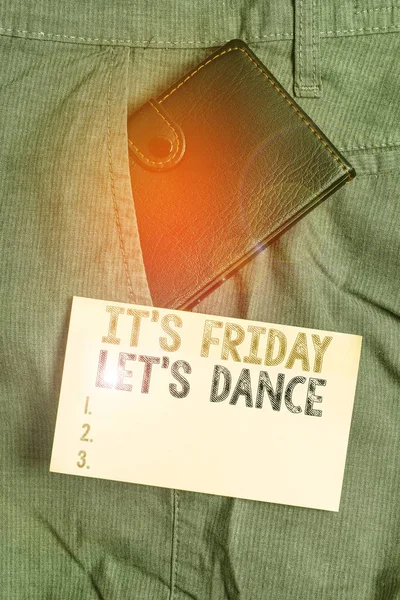 Writing note showing It s is Friday Let s is Dance. Business concept for Celebrate starting the weekend Go party Disco Music Small wallet inside trouser front pocket near notation paper