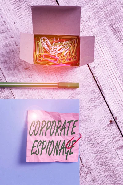 Conceptual hand writing showing Corporate Espionage. Concept meaning form of espionage conducted for commercial purpose Wrinkle paper and cardboard placed above wooden background