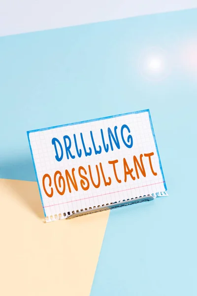 Text sign showing Drilling Consultant. Business photo showcasing onsite supervision of daytoday drilling operations Paper placed tilted above buffer wire on soft pastel multi colours backdrop