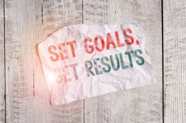 Text sign showing Set Goals, Get Results. Business photo showcasing Establish objectives work for accomplish them Crumpled torn paper half broken placed above classic wooden background