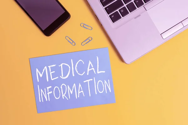 Text sign showing Medical Information. Conceptual photo Healthrelated information of a patient or a demonstrating Trendy open laptop smartphone small paper sheet clips colored background.