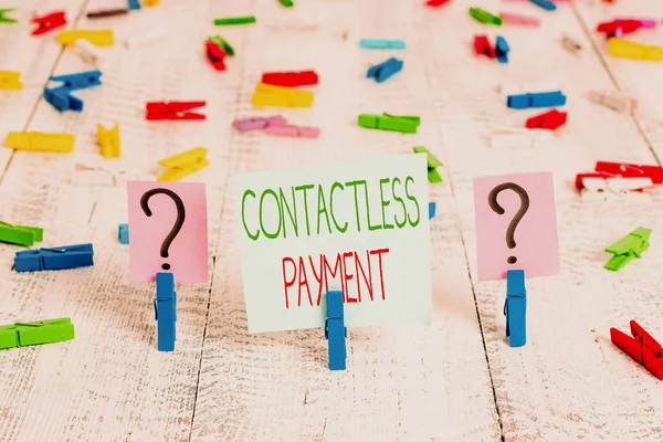 Text sign showing Contactless Payment. Conceptual photo use near field communication for making secure payments Scribbled and crumbling sheet with paper clips placed on the wooden table. — 스톡 사진