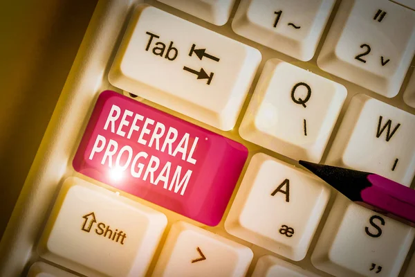 Writing note showing Referral Program. Business concept for employees are rewarded for introducing suitable recruits White pc keyboard with note paper above the white background