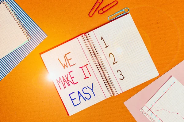 Conceptual hand writing showing We Make It Easy. Concept meaning Offering solutions alternatives make an easier job ideas Striped paperboard cardboard office study supplies chart