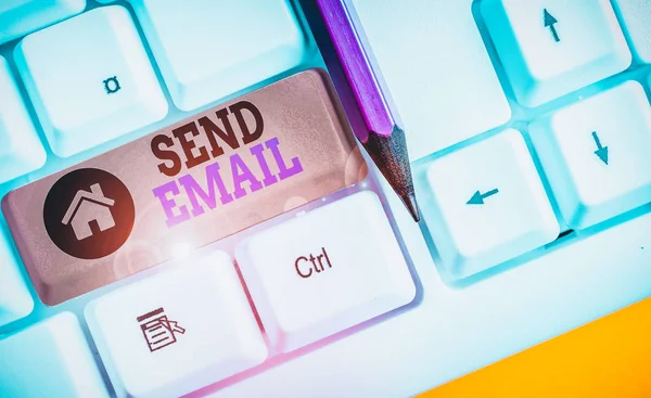 Handwriting text writing Send Email. Conceptual photo the system for using computers to send messages over the internet White pc keyboard with empty note paper above white background key copy space