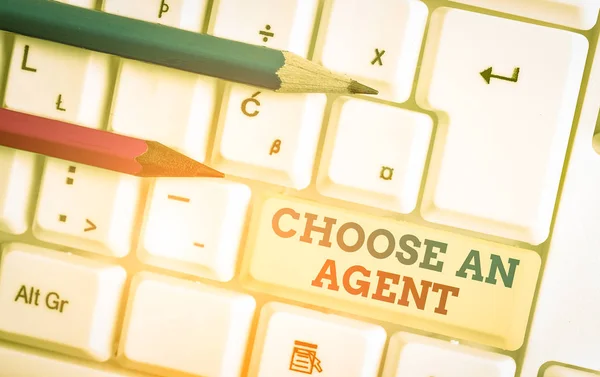 Writing note showing Choose An Agent. Business concept for Choose someone who chooses decisions on behalf of you White pc keyboard with note paper above the white background