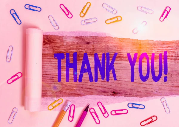 Writing note showing Thank You. Business concept for polite expression used when acknowledging gift service compliment Stationary and torn cardboard on a wooden classic table backdrop