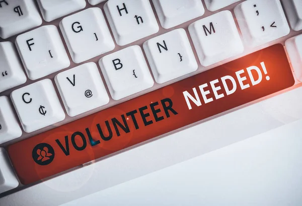 Writing note showing Volunteer Needed. Business concept for need work for organization without being paid White pc keyboard with note paper above the white background