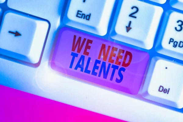 Writing note showing We Need Talents. Business concept for seeking for creative recruiters to join company or team