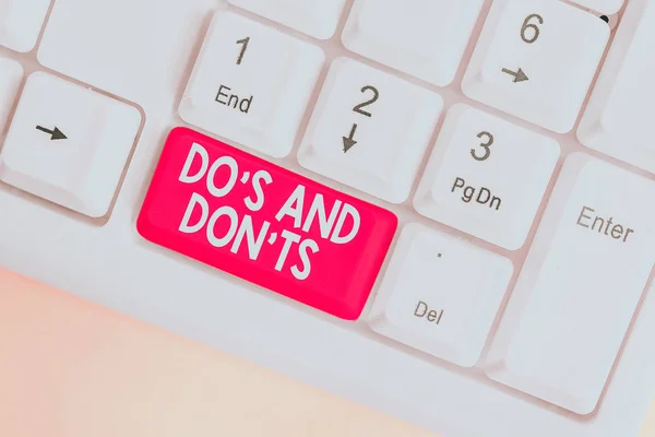 Text sign showing Do S And Don tS. Business photo text Rules or customs concerning some activity or actions White pc keyboard with empty note paper above white background key copy space