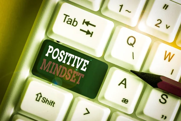 Writing note showing Positive Mindset. Business concept for mental attitude in wich you expect favorable results White pc keyboard with note paper above the white background