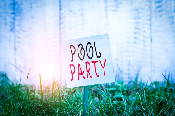 Text sign showing Pool Party. Business photo showcasing celebration that includes activitites in a swimming pool Plain empty paper attached to a stick and placed in the green grassy land