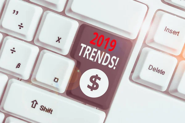 Writing note showing 2019 Trends. Business concept for general direction in which something is developing or changing White pc keyboard with note paper above the white background