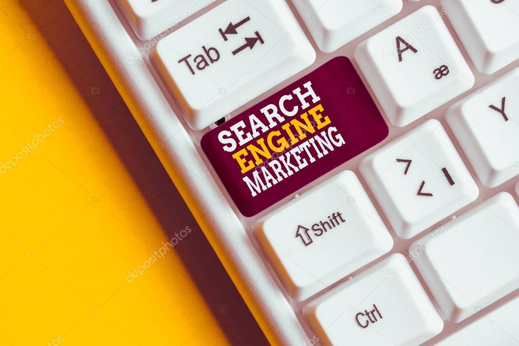 Writing note showing Search Engine Marketing. Business concept for promote Website visibility on searched result pages White pc keyboard with note paper above the white background