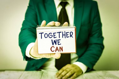 Conceptual hand writing showing Together We Can. Concept meaning unity can makes everything possible One powerful group Man holds empty paper with copy space in front of him Space clipart