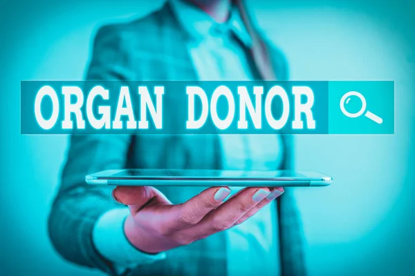 Writing note showing Organ Donor. Business concept for the act of donating an organ to a demonstrating needed a transplant Business concept with mobile phone and business woman