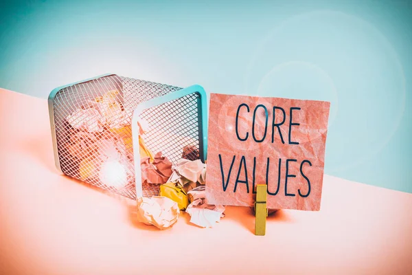 Conceptual hand writing showing Core Values. Concept meaning the fundamental beliefs or principle of a demonstrating or organization Trash bin crumpled paper clothespin reminder office supplies