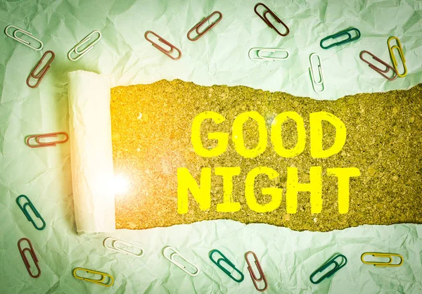 Text sign showing Good Night. Business photo text expressing good wishes on parting at night or before going to bed Paper clip and torn cardboard placed above a wooden classic table backdrop