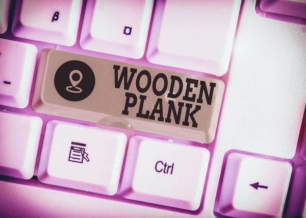 Conceptual hand writing showing Wooden Plank. Concept meaning wood or similar material of the type used for making floors White pc keyboard with note paper above the white background