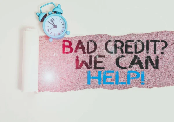 Handwriting text writing Bad Credit Question We Can Help. Conceptual photo offering help after going for loan then rejected Alarm clock and torn cardboard placed above a wooden classic table backdrop