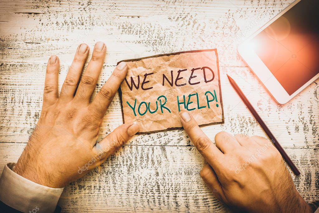 Handwriting text writing We Need Your Help. Conceptual photo asking someone to stand with you against difficulty Hand hold note paper near writing equipment and modern smartphone device