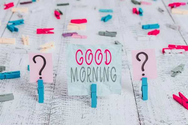 Conceptual hand writing showing Good Morning. Concept meaning expressing good wishes on meeting or parting during the morning Crumbling sheet with paper clips placed on the wooden table