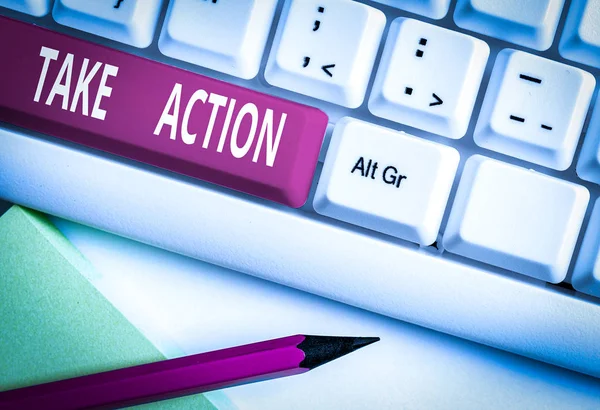Text sign showing Take Action. Business photo text to do somethingoract in order to get a particular result White pc keyboard with empty note paper above white background key copy space