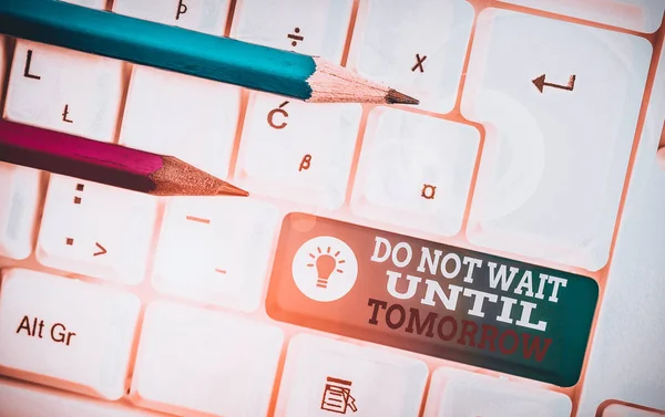 Text sign showing Do Not Wait Until Tomorrow. Business photo showcasing needed to do it right away Urgent Better do now White pc keyboard with empty note paper above white background key copy space